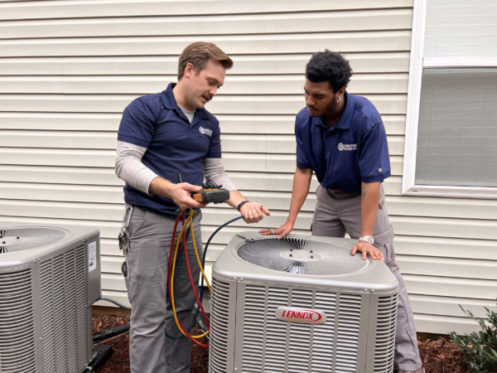 Technicians standing by AC unit in Charleston, SC