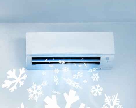 An air conditioner with visible representation of cold air blowing shown by snowflakes